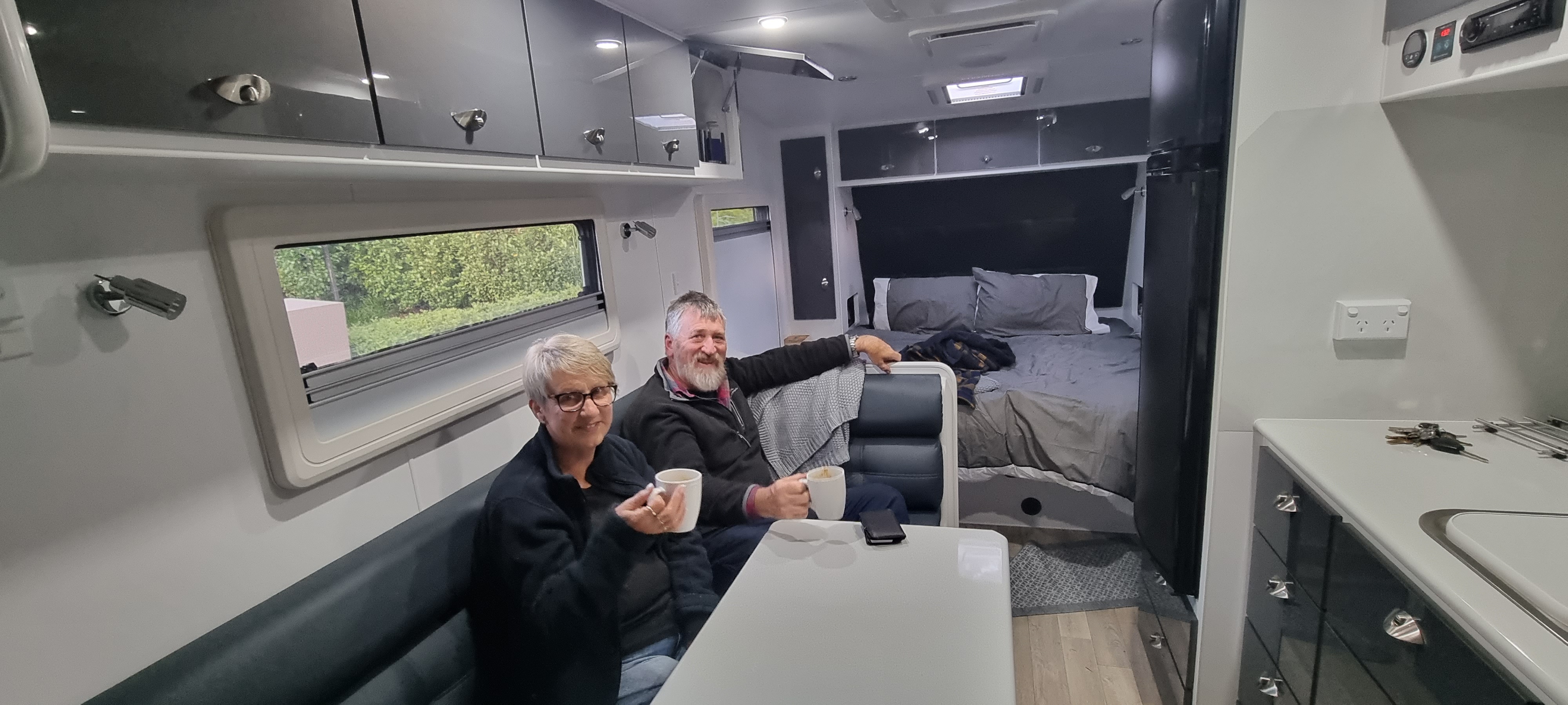 Karen and Stephen sharing a cuppa in their caravan